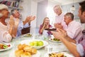 Mother Serves Birthday Cake To Adult Daughter At Family Meal Royalty Free Stock Photo