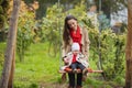 Mother shakes her baby on swing at the autumn park. Happy family spend time together Royalty Free Stock Photo