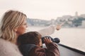 Mother showing away to son with binoculars looking, gazing, sear