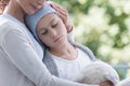 Mother and sick teenager daughter with cancer in the garden of home hospice