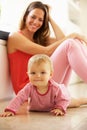 Mother Sitting With Baby Daughter At Home