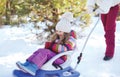 Mother sledding child in winter