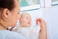 Mother and sleeping child near the window .Happy loving family.