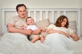 Mother sleeps while father takes care of the baby boy, parents and infa Royalty Free Stock Photo