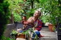 Mother with small daughter gardening on farm, growing organic vegetables.