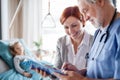 Mother of small hospitalized girl talking to doctor in hospital. Royalty Free Stock Photo