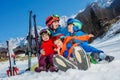 Mother with small kids sit in the snow wear sport outfit Royalty Free Stock Photo