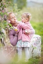 Mother with small toddler daughter holding and smelling apple tr Royalty Free Stock Photo