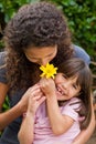 Mother smelling a flower with her daughter Royalty Free Stock Photo