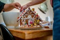 Building and decorating a festive ginger bread house Royalty Free Stock Photo