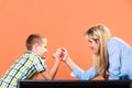 Mother and son arm wrestling.