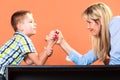 Mother and son arm wrestling.