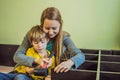 Mother and son assembling furniture. Boy helping his mom at home. Happy Family concept Royalty Free Stock Photo