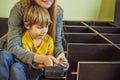 Mother and son assembling furniture. Boy helping his mom at home. Happy Family concept Royalty Free Stock Photo