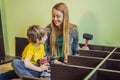 Mother and son assembling furniture. Boy helping his mom at home. Happy Family concept Royalty Free Stock Photo