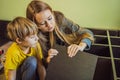 Mother and son assembling furniture. Boy helping his mom at home. Happy Family concept Royalty Free Stock Photo