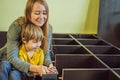 Mother and son assembling furniture. Boy helping his mom at home. Happy Family concept Royalty Free Stock Photo