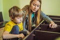 Mother and son assembling furniture. Boy helping his mom at home. Happy Family concept Royalty Free Stock Photo