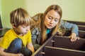 Mother and son assembling furniture. Boy helping his mom at home. Happy Family concept Royalty Free Stock Photo