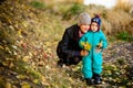 Mother with son in autumn peach garden Royalty Free Stock Photo