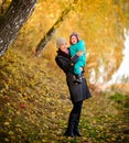 Mother with son in autumn peach garden Royalty Free Stock Photo