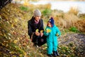 Mother with son in autumn peach garden Royalty Free Stock Photo