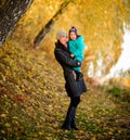 Mother with son in autumn peach garden Royalty Free Stock Photo