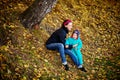 Mother with son in autumn peach garden Royalty Free Stock Photo