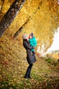 Mother with son in autumn peach garden Royalty Free Stock Photo