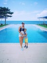 Mother and son on the background of a rectangular pool near the sea Royalty Free Stock Photo