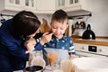 Mother and son baking cake in the kitchen. Lifestyle casual capture of family cooking