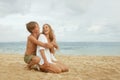 Mother And Son On Beach. Handsome Boy Hugs Young Woman On Coast. Happy Family Looking Lovely On Summer Vacation.