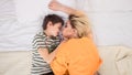 Mother with son on bed, mother and son having fun Royalty Free Stock Photo