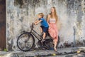 Mother and son on a bicycle. Public street art Name Children on a bicycle painted 3D on the wall that`s two little Chinese girls Royalty Free Stock Photo