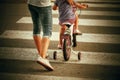 Mother with son with a bike on a zebra. Back view Royalty Free Stock Photo