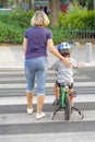 Mother with son with a bike on a zebra Royalty Free Stock Photo