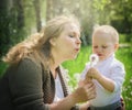 Mother and son blowing on a dandelion Royalty Free Stock Photo