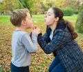 Mother and son blowing dandelion Royalty Free Stock Photo