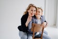 A mother with son in blue clothes having fun and poses for a photo shoot