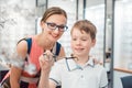 Mother and son both liking the eyeglasses offered in optician shop Royalty Free Stock Photo