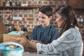 Little boy and his young mother working on a wooden birdhouse