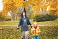 Mother and son child walking in autumn park Royalty Free Stock Photo