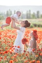 Mother, son and daughter in a field of red poppies Royalty Free Stock Photo