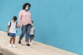 Mother with son and daughter going back to school wearing safety masks - Focus on mom face Royalty Free Stock Photo