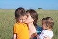 Mother with son and daughter in the summer field