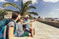 Mother, son and daughter together at seacoast with luggage backpack make selfie photo. Travel, tourism, family concept Royalty Free Stock Photo