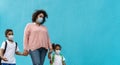 Mother with son and daughter wearing face protective mask going back to school during corona virus pandemic Royalty Free Stock Photo