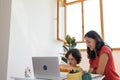 Mother and son do their homework online. distance learning online education. Home education.Schoolboy with laptop and doing Royalty Free Stock Photo