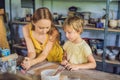 Mother and son doing ceramic pot in pottery workshop Royalty Free Stock Photo