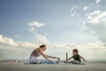 Mother and son doing exercise on the balcony in the background of a city during sunrise or sunset, concept of a healthy lifestyle Royalty Free Stock Photo